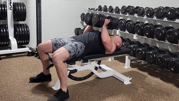 Dr. Merrick Lincoln performing dumbbell hex press