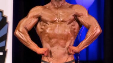 Muscular bodybuilder posing on stage