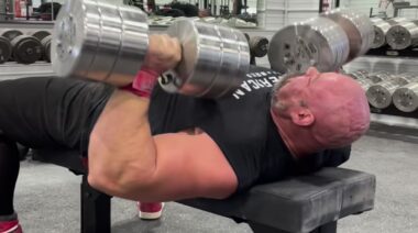 Strongman Brian Show performing dumbbell bench press