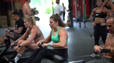 CrossFit athletes in gym using rowing machines