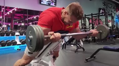 Bodybuilder Jay Cutler in gym doing barbell curl