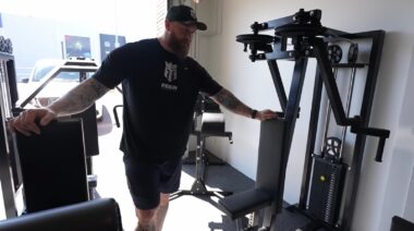 Hafthor Bjornsson standing in gym near exercise equipment