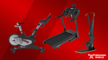 An exercise bike, ski erg, and treadmill on a red background
