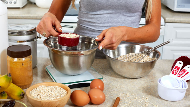 person in kitchen mixing ingredients for recipe