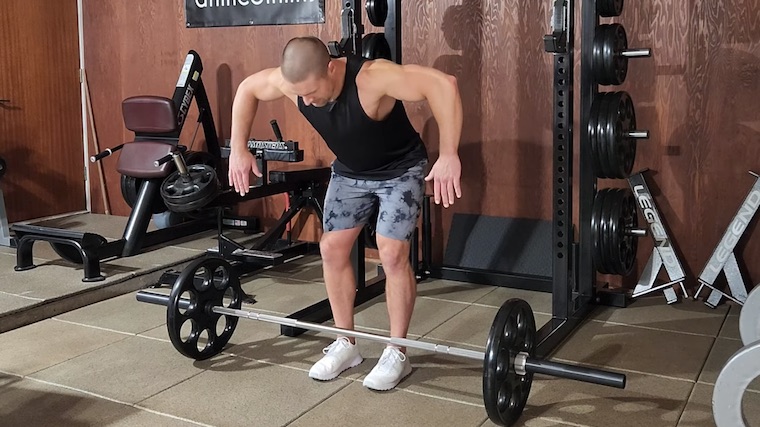 Dr. Merrick Lincoln in gym demonstrating barbell row