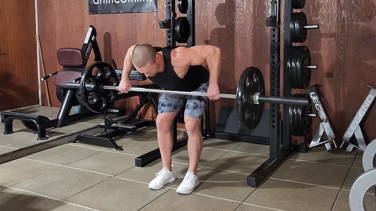 Dr. Merrick Lincoln in gym demonstrating barbell row