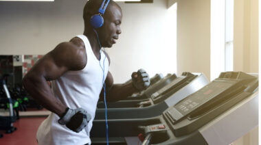 Muscular person running on treadmill