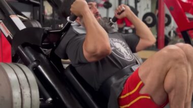 Bodybuilder Alberto Nunez in gym using hack squat machine