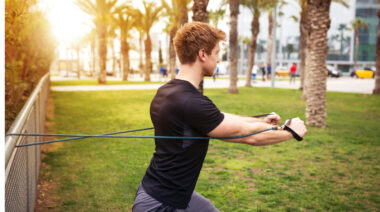 Person doing resistance band exercise outdoors