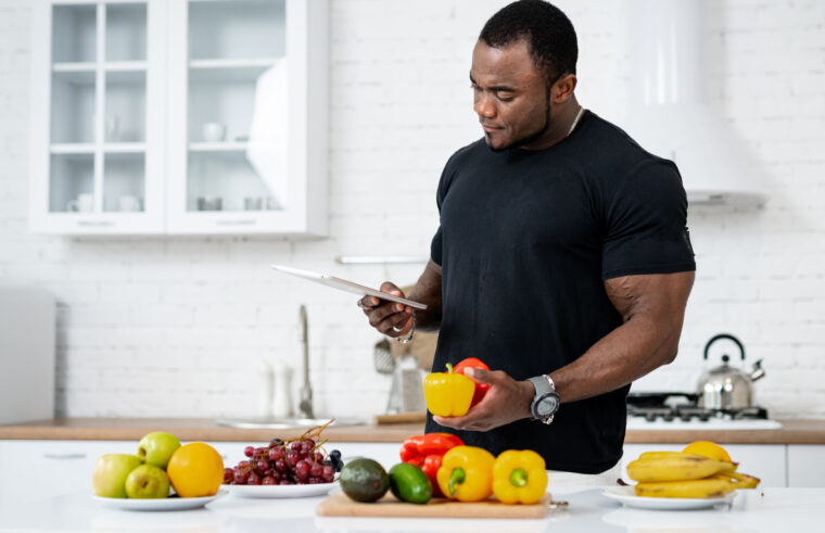 Muscular person in kitchen with food
