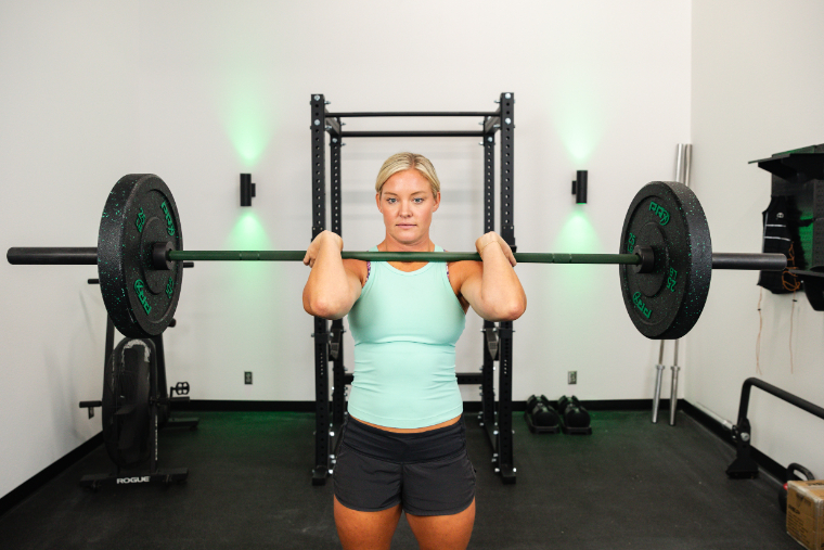 A woman getting ready to do front squats with the REP Colorado Bar