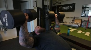 Hafthor Björnsson performing an incline press with 150-pound dumbbells.