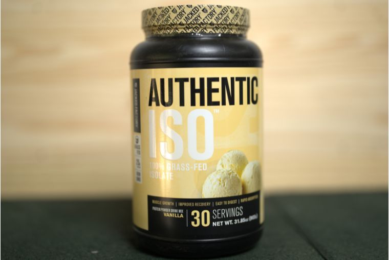 A container of Jacked Factory Authentic ISO on a black surface with a wood background