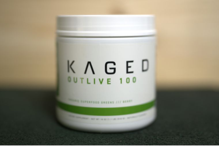 A container of Kaged Outlive 100 on a black surface