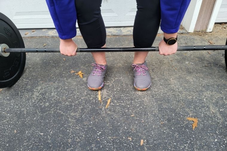 A young woman deadlifting in the NOBULL Trainers