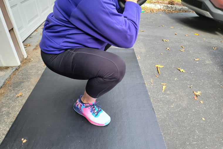 A woman doing squats while wearing the TYR CXT-1 Trainers