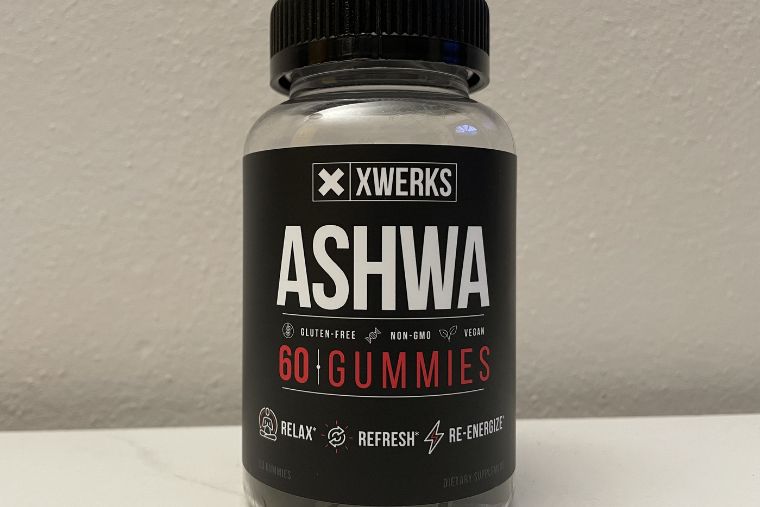 A bottle of XWERKS Ashwa against a white wall