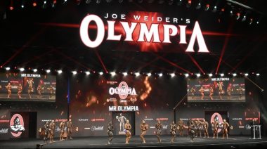 Mr. Olympia contestants pose on stage at the 2022 event.