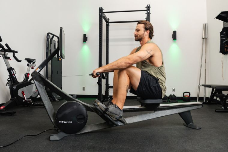 A young man working out on the Hydrow Wave