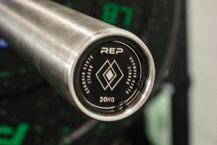A close-up of the endcap on the REP Fitness Double Black Diamond Barbell