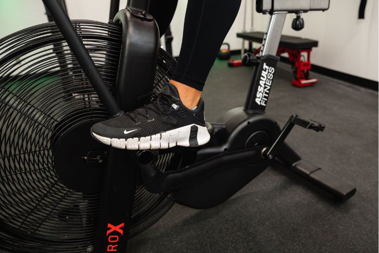 A close-up of an athlete's foot on the foot peg on the AssaultBike Pro X