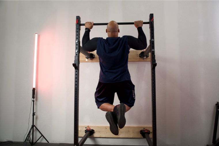 A man doing pull-ups on the Titan T-3 Foldable Power Rack