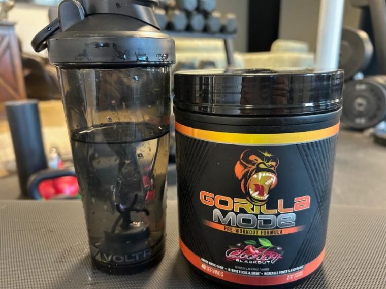 Gorilla Mode pre-workout next to a shaker bottle filled with water