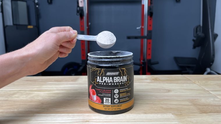 Person measuring a scoop of Onnit Alpha Brain